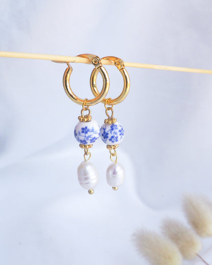 Gold hoop earrings with blue and white ceramic beads and pearl-like stones on a light gray background. Portuguese Gold Azulejo Pearl Earrings from Portugal, Lisbon Tlle Jewelry