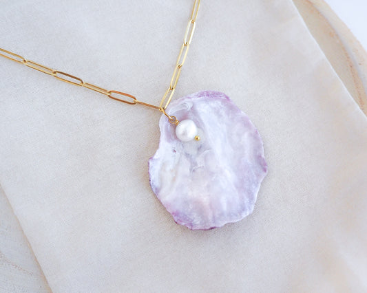 Big Pink Mother of Pearl Jingle Shell Necklace with Freshwater Pearl on display