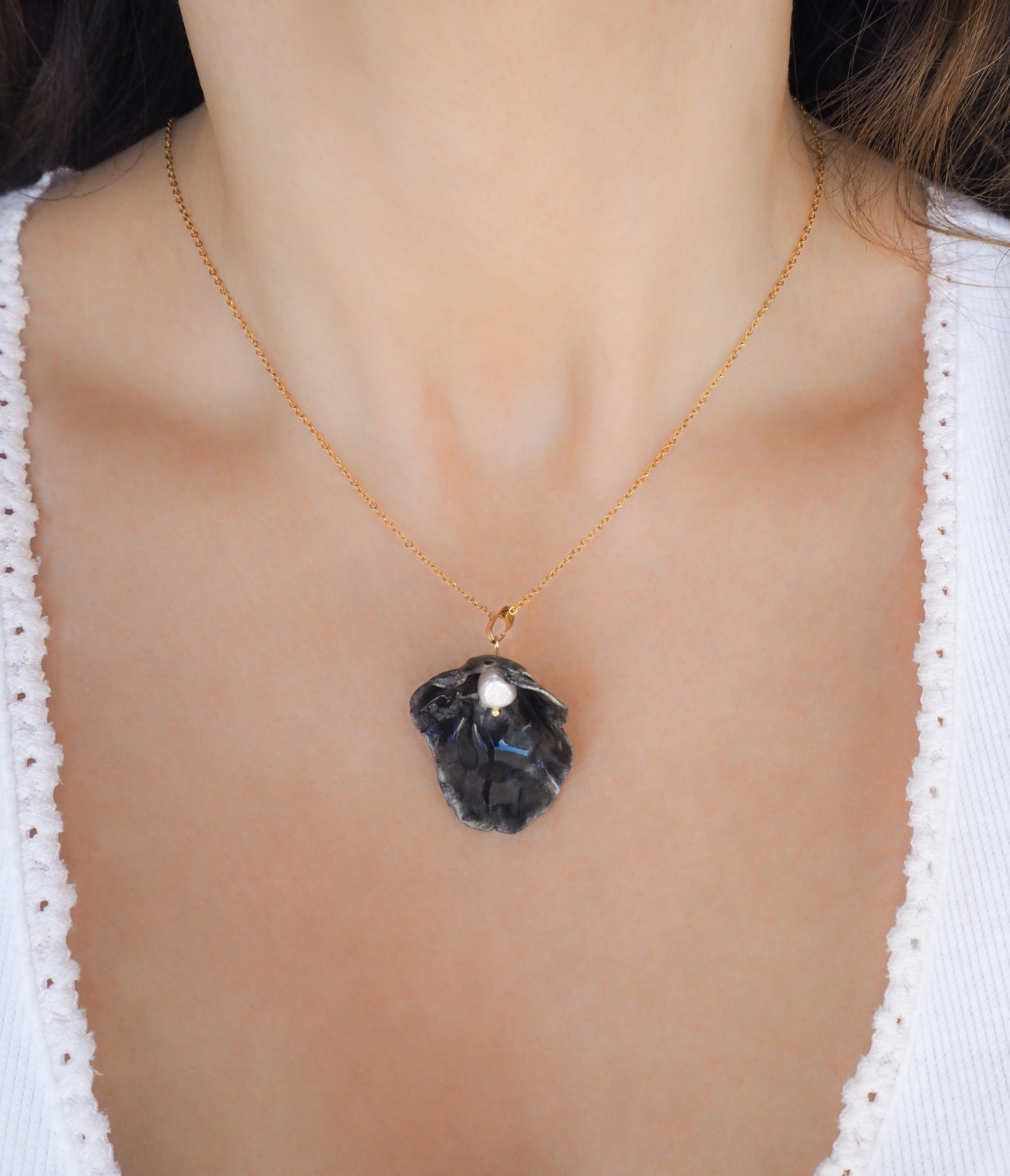 Gold Black Jingle Shell Necklace on neck, Dark Mother of Pearl Pendant