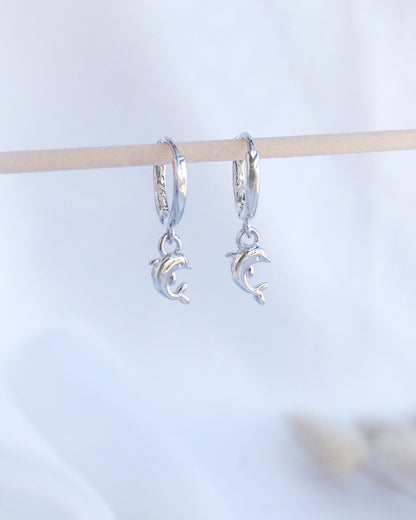 Silver Dolphin Earring Hoops. Front view of Silver Dolphin Earrings. Tiny dolphin pendants hoop earrings made of 925 sterling silver