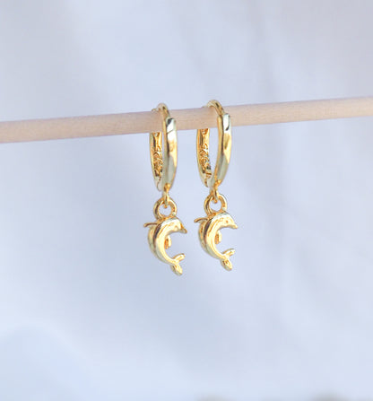 Front view of Gold Dolphin Earrings. Tiny dolphin pendants hoop earrings made of 14k gold vermeil 925 sterling silver