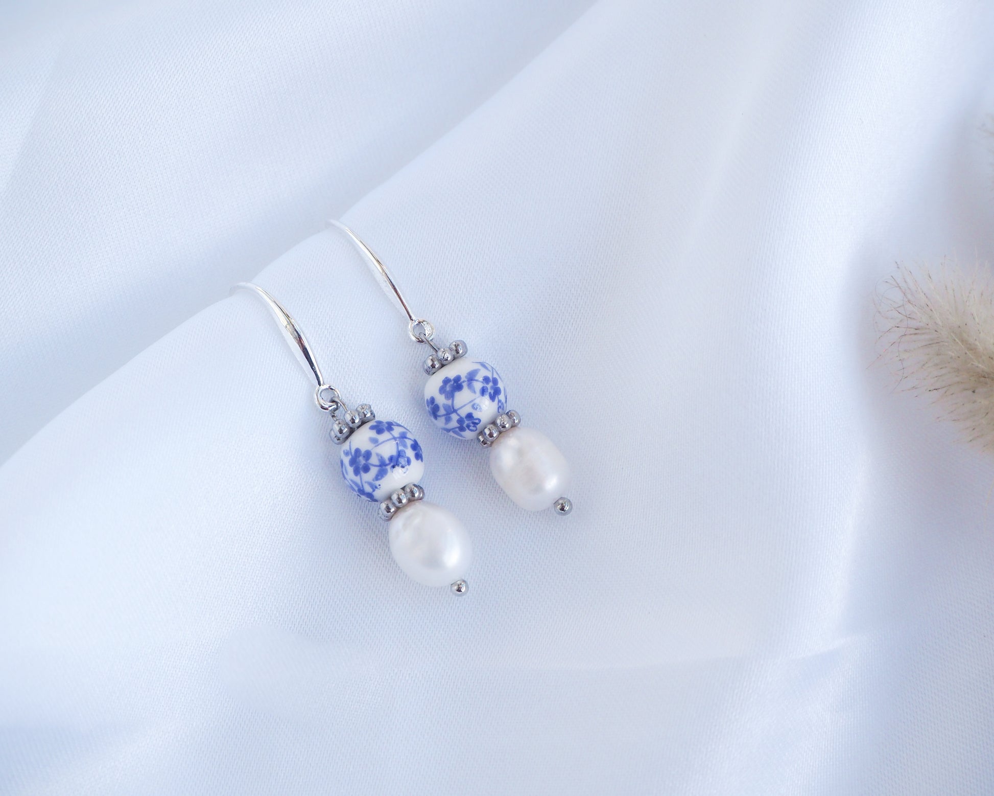 Silver earrings with blue and white floral beads and pearls on a white background. Azulejo Silver Earrings from Portugal, Portuguese Tlles, Blue White Flower Porcelain Earrings