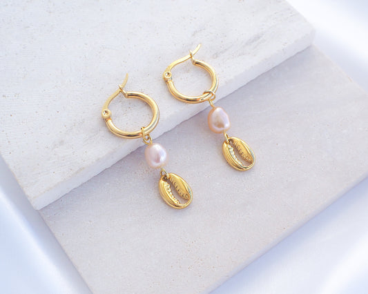 Gold Hoop Earrings with Cowrie Shells and Pearls on stone. Made with premium 14k and 18k gold stainless steel and pink freshwater pearl beads. 