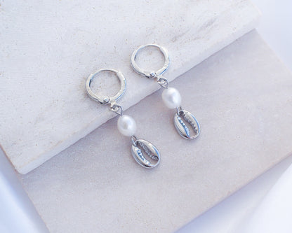 Silver Hoop Earrings with Cowrie Shells and Pearls on stone. Made with 925 sterling silver and white freshwater pearl beads. 