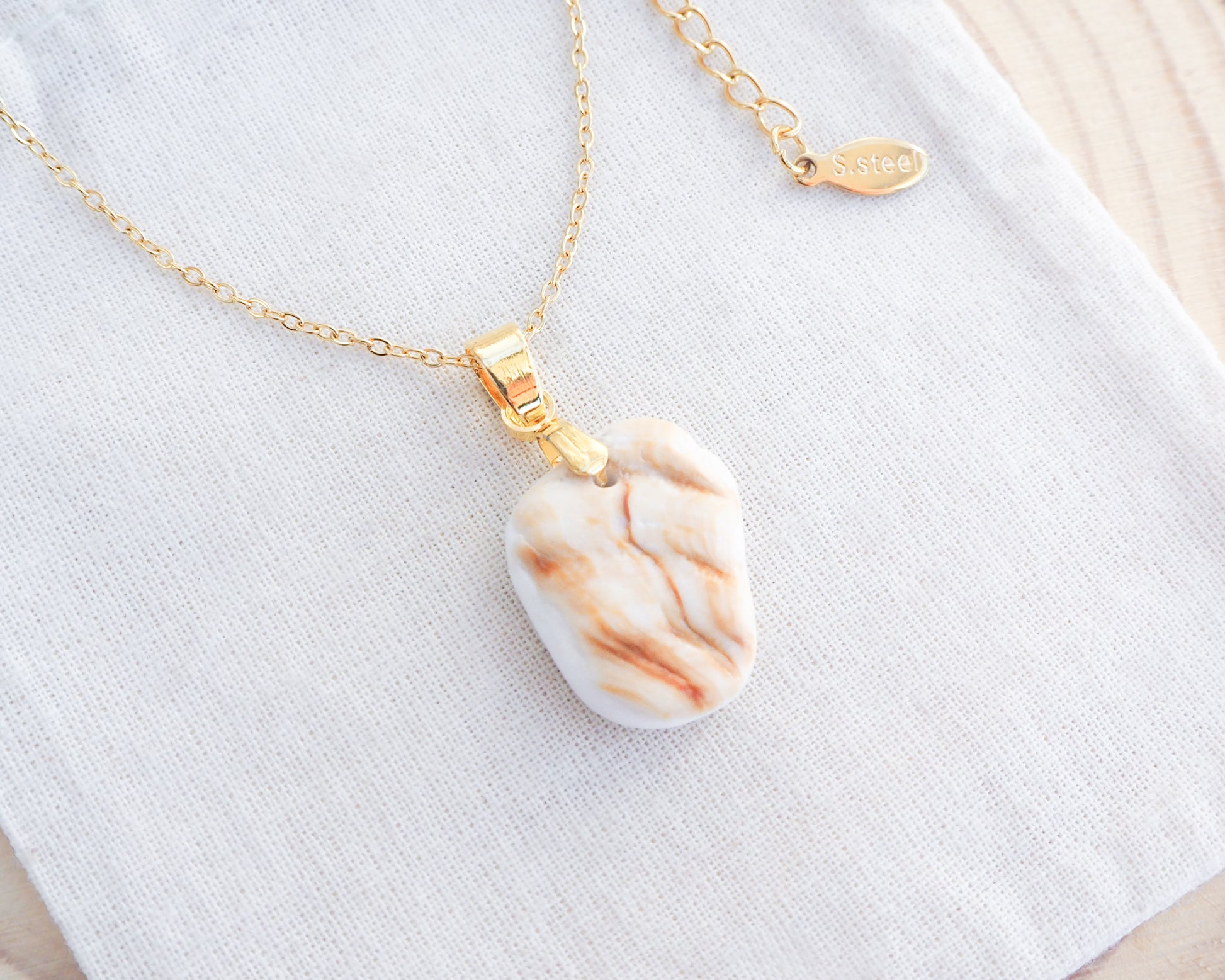 Mediterranean Cockle Shell Piece Gold Necklace on display, Sunny Shell Necklace from Portugal