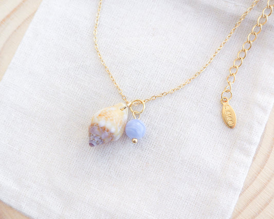 Tiny Light Rustic Dove with Angelite Gemstone Gold Necklace on display