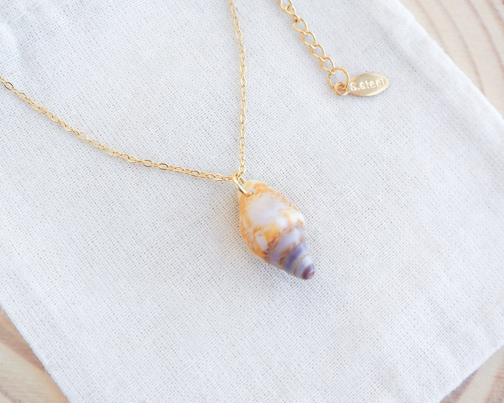Tiny Light Rustic Dove Shell Gold Necklace on display front view, Dove Shell Necklace from Portugal, Real Shell Necklace, Sea by Lou