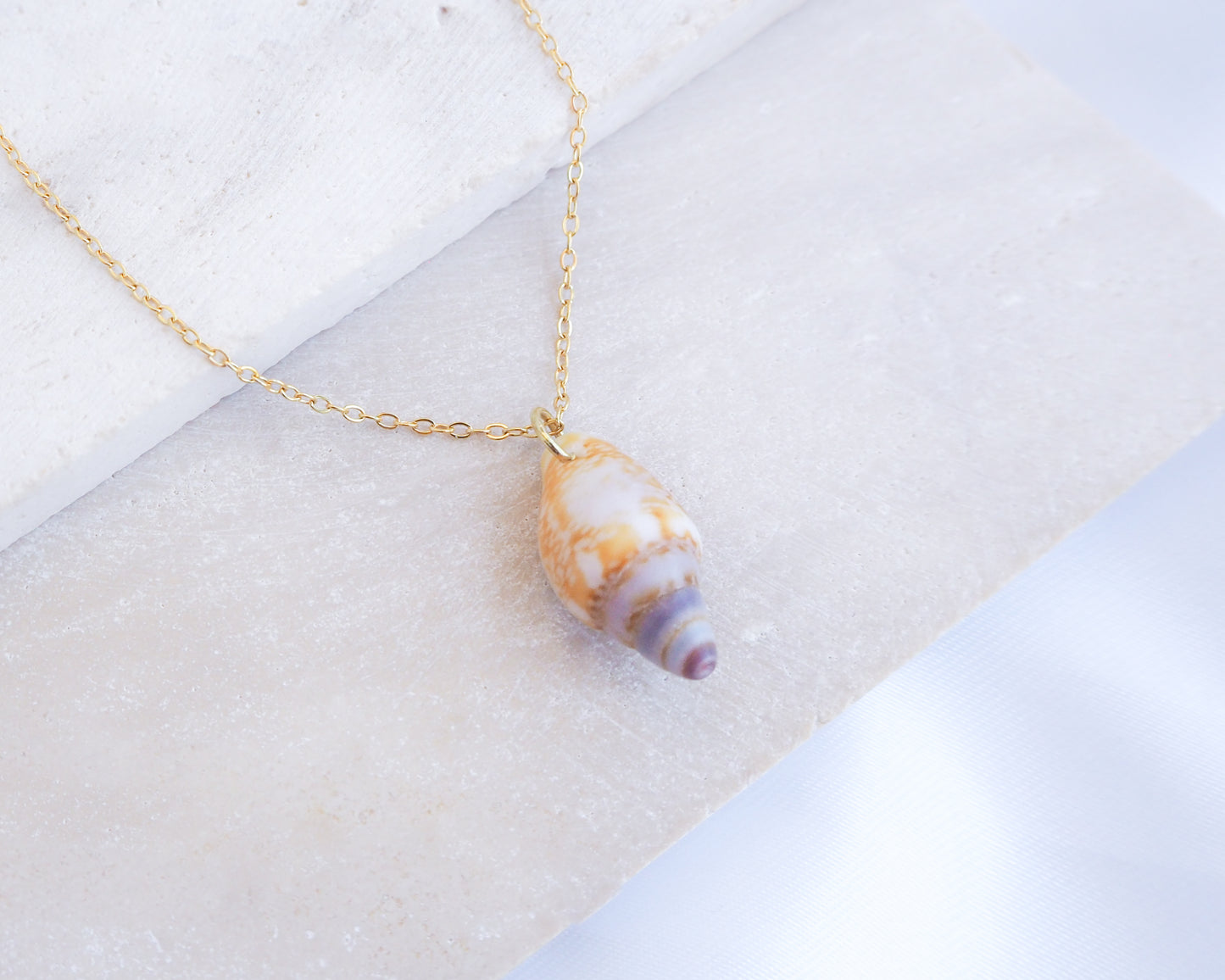 Tiny Light Rustic Dove Shell Gold Necklace displayed on stone front view, Dove Shell Necklace from Portugal, Real Shell Necklace, Sea by Lou
