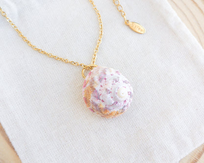 Sunny Pink White Orange Magus Top Shell Gold Necklace on display 