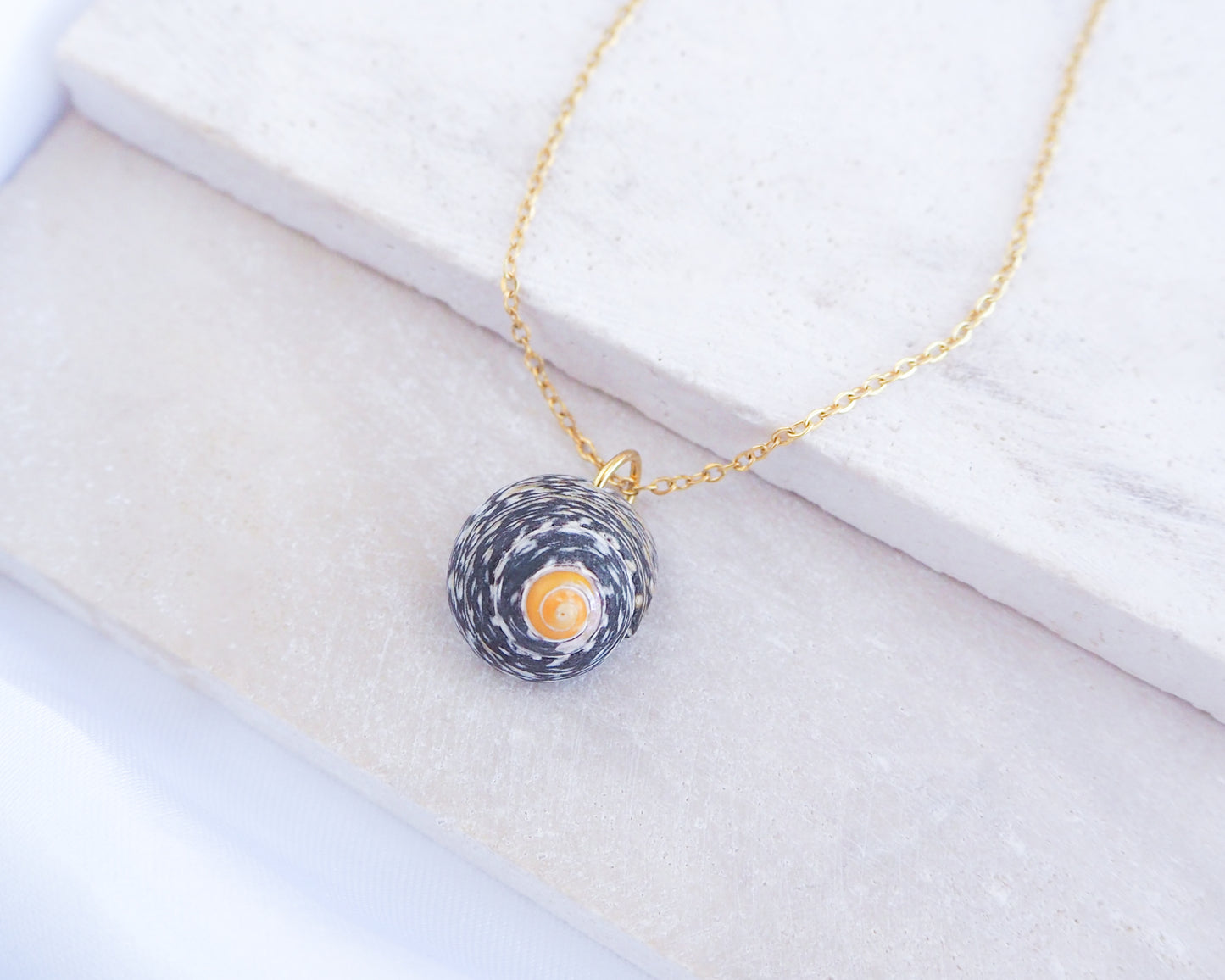 Shell pendant necklace on a white background. Gold Lined Top Shell Necklace, Shell from Portugal side view