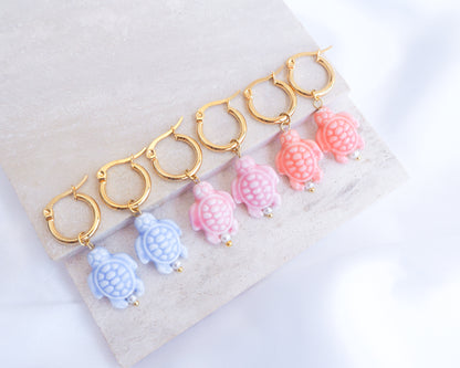 Set of colorful turtle-shaped earrings on a white background. Blue, Pink, Coral Turtle Ceramic Gold Earrings on display