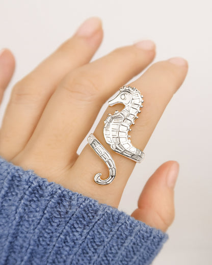 Model wearing silver seahorse ring on stone background, hippocampus ring 14k gold stainless steel