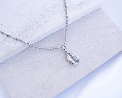 Silver Cowrie Necklace on stone 
