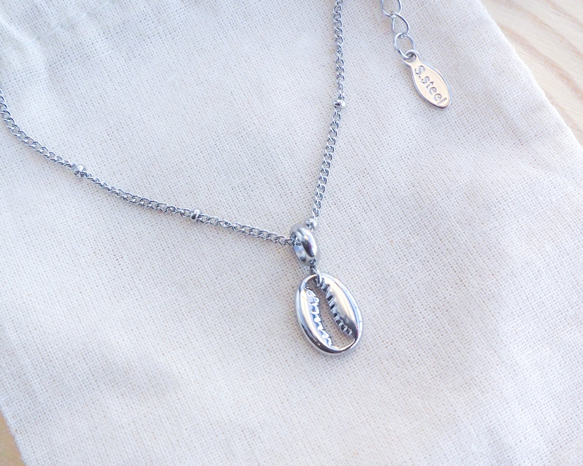 Silver Cowrie Necklace on display