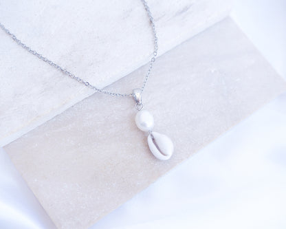 Silver Cowrie Shell Pearl Necklace Freshwater Pearl Pearl on stone displayed
