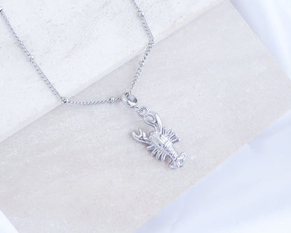 Silver Lobster Necklace on stone displayed, made with silver stainless steel, coastal jewelry from Portugal