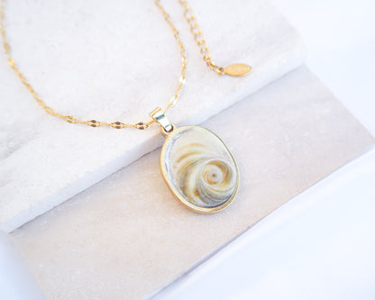 Soft Green Eye of Saint Lucia Gold Necklace on stone displayed, 18k gold stainless steel shiva eye pendant necklace, Saint Lucy Eye, operculum pendant