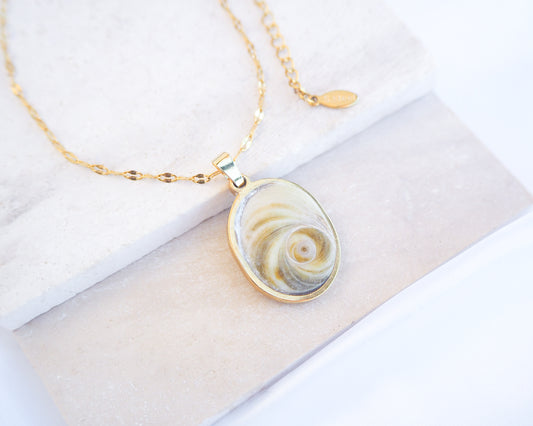 Soft Green Eye of Saint Lucia Gold Necklace on stone displayed, 18k gold stainless steel shiva eye pendant necklace, Saint Lucy Eye, operculum pendant