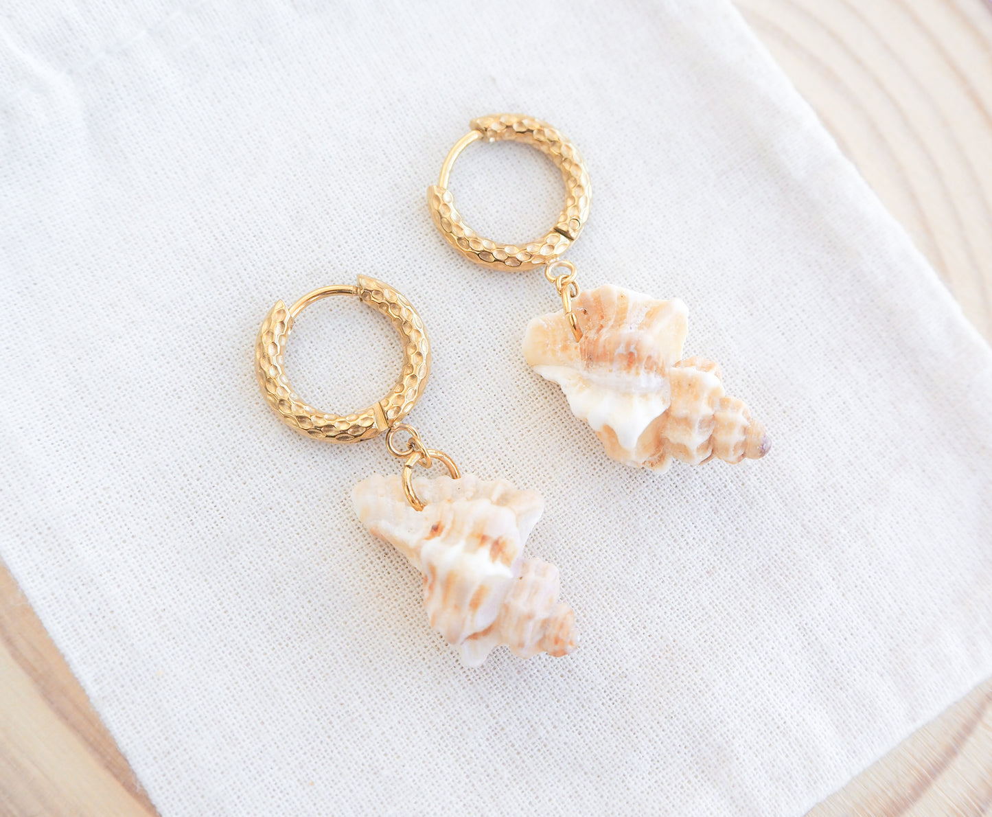Sting Winkle Shell Earrings Gold Hoops Earrings on display