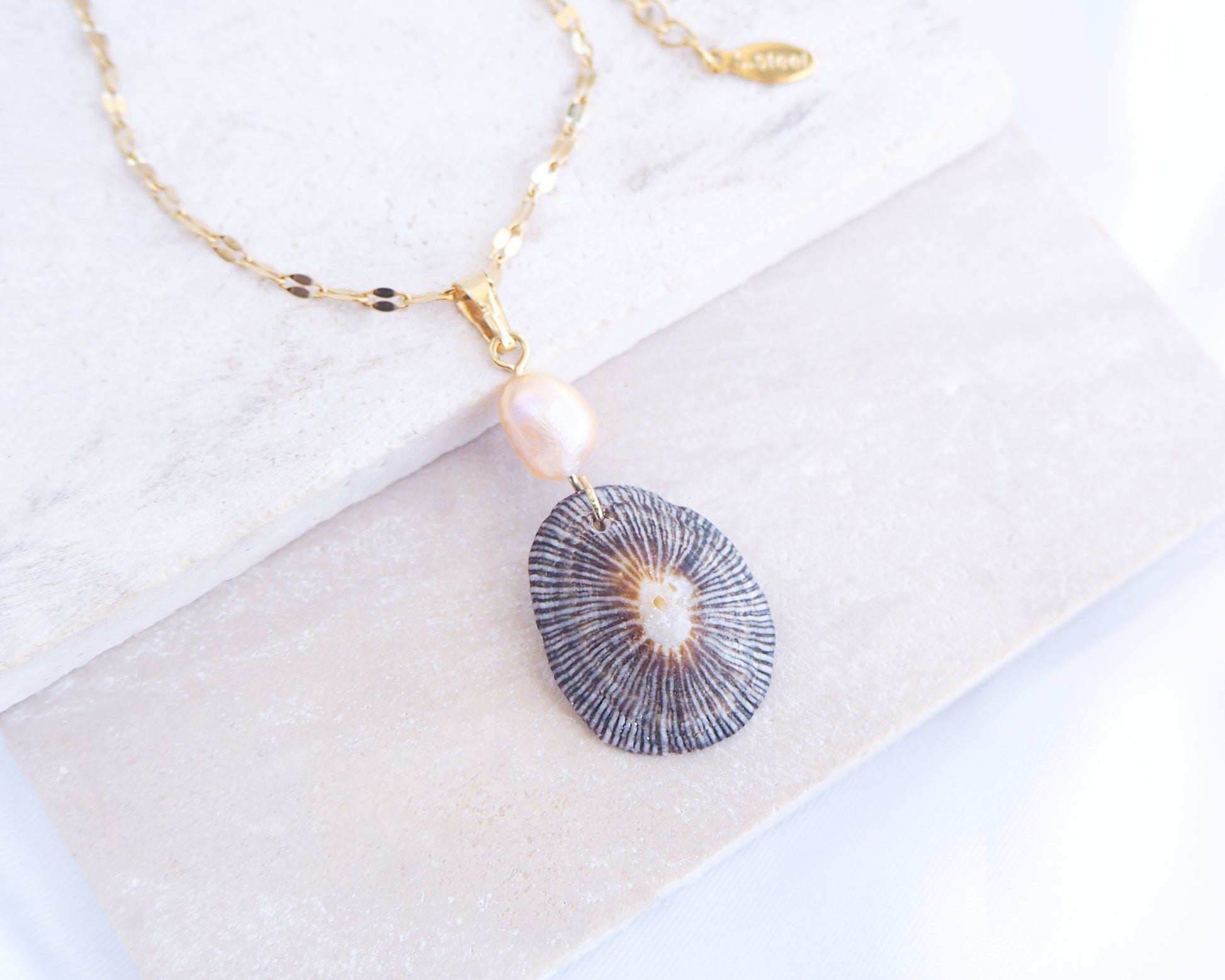 Front view of Striped Limpet Shell Pearl Necklace on display, Dark Limpet Shell from Portugal with freshwater pearl and gold chain. 