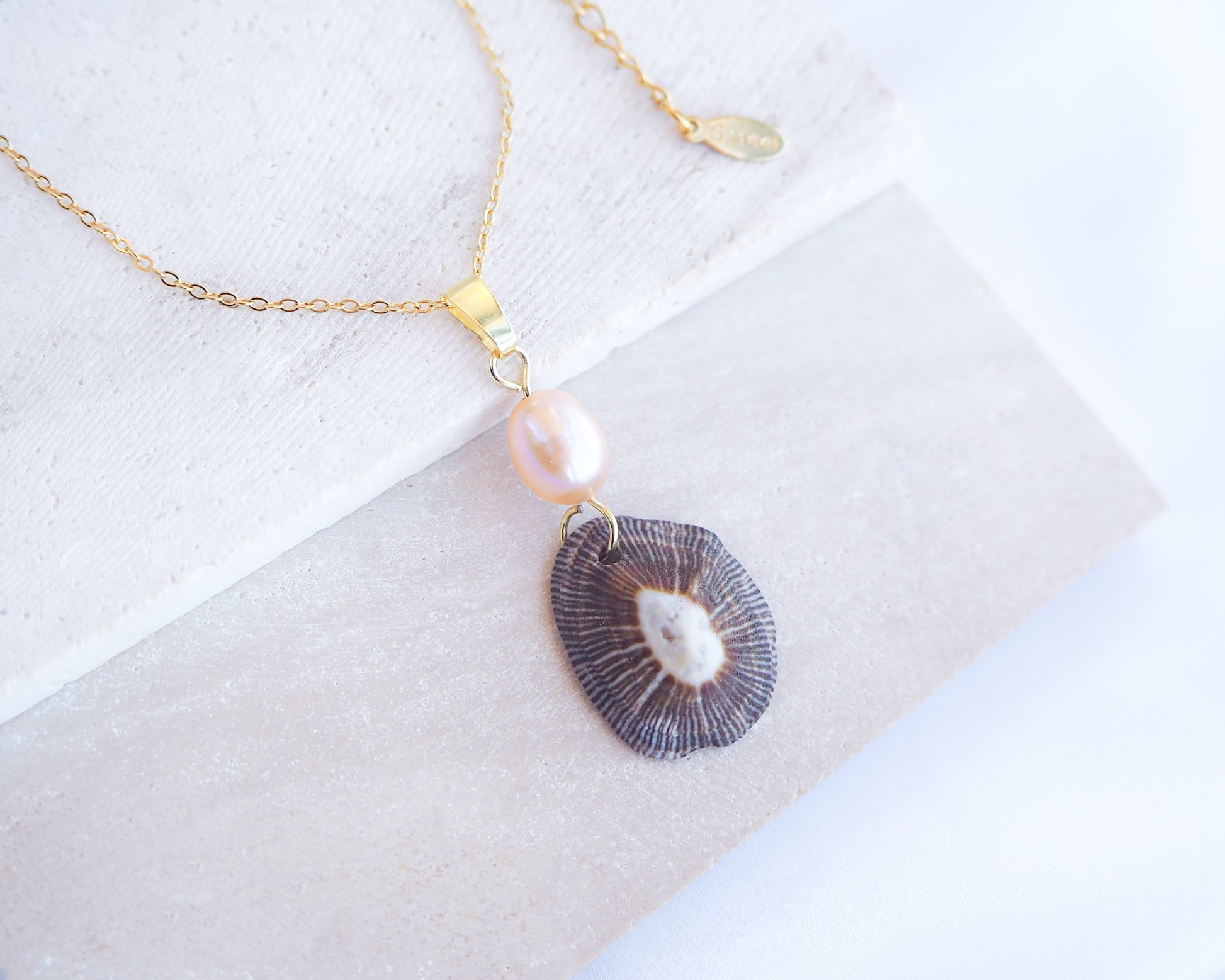 Front view of Striped Limpet Shell Rose Pearl Necklace on display, Dark Limpet Shell from Portugal with freshwater pearl and gold chain. 