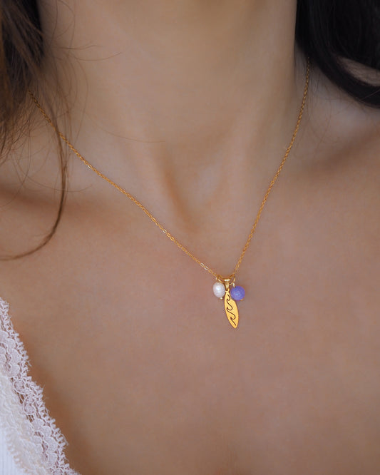 Gold Surfboard Necklace Pearl and Angelite Beads on model – Ocean Inspired Jewelry
