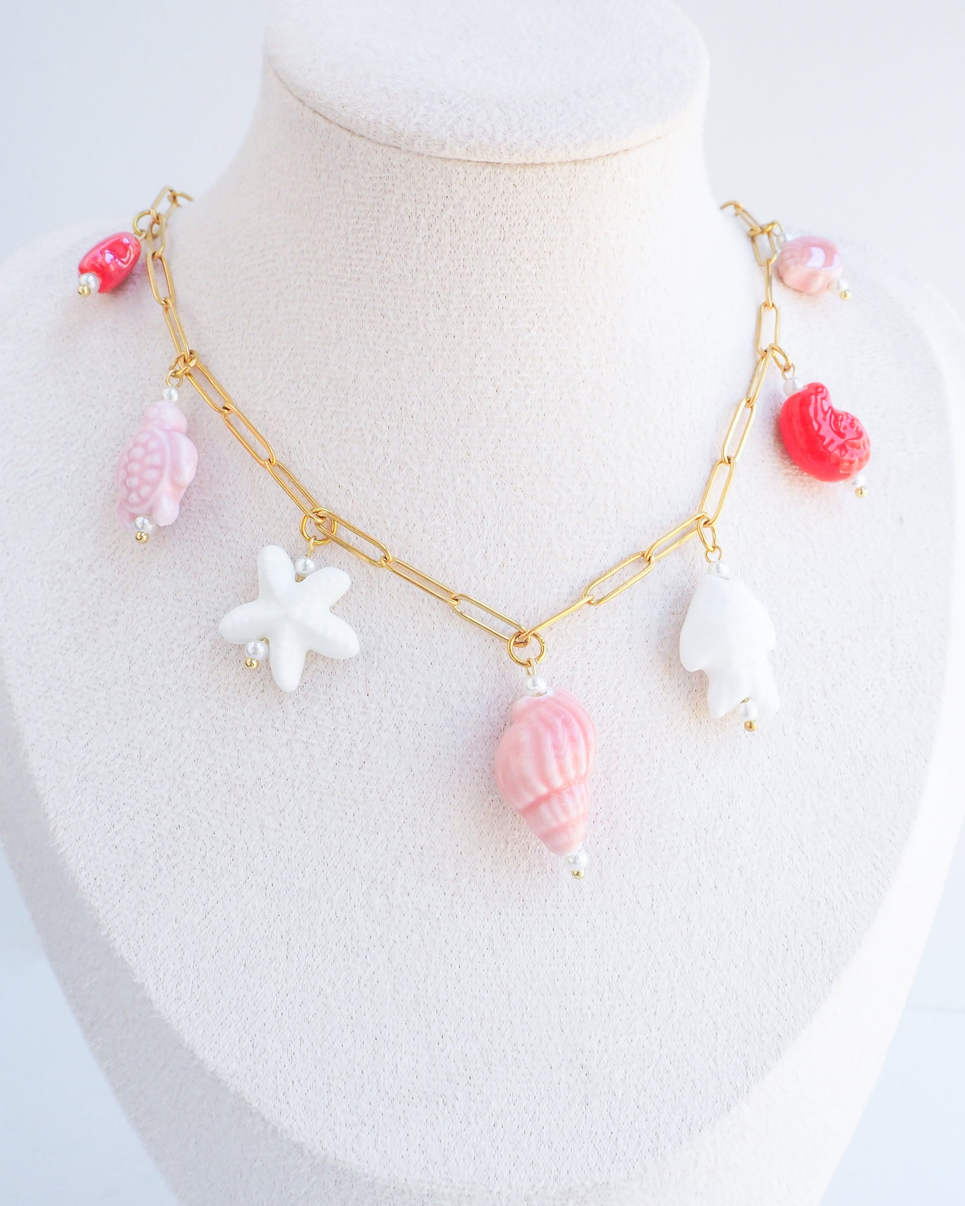 Sweet Ocean Ceramic Charm Necklace with 7 ceramic ocean charms (turtle, starfish, fish, shell & more), Pink white red sea pendants, 18k gold stainless steel chain on neck 