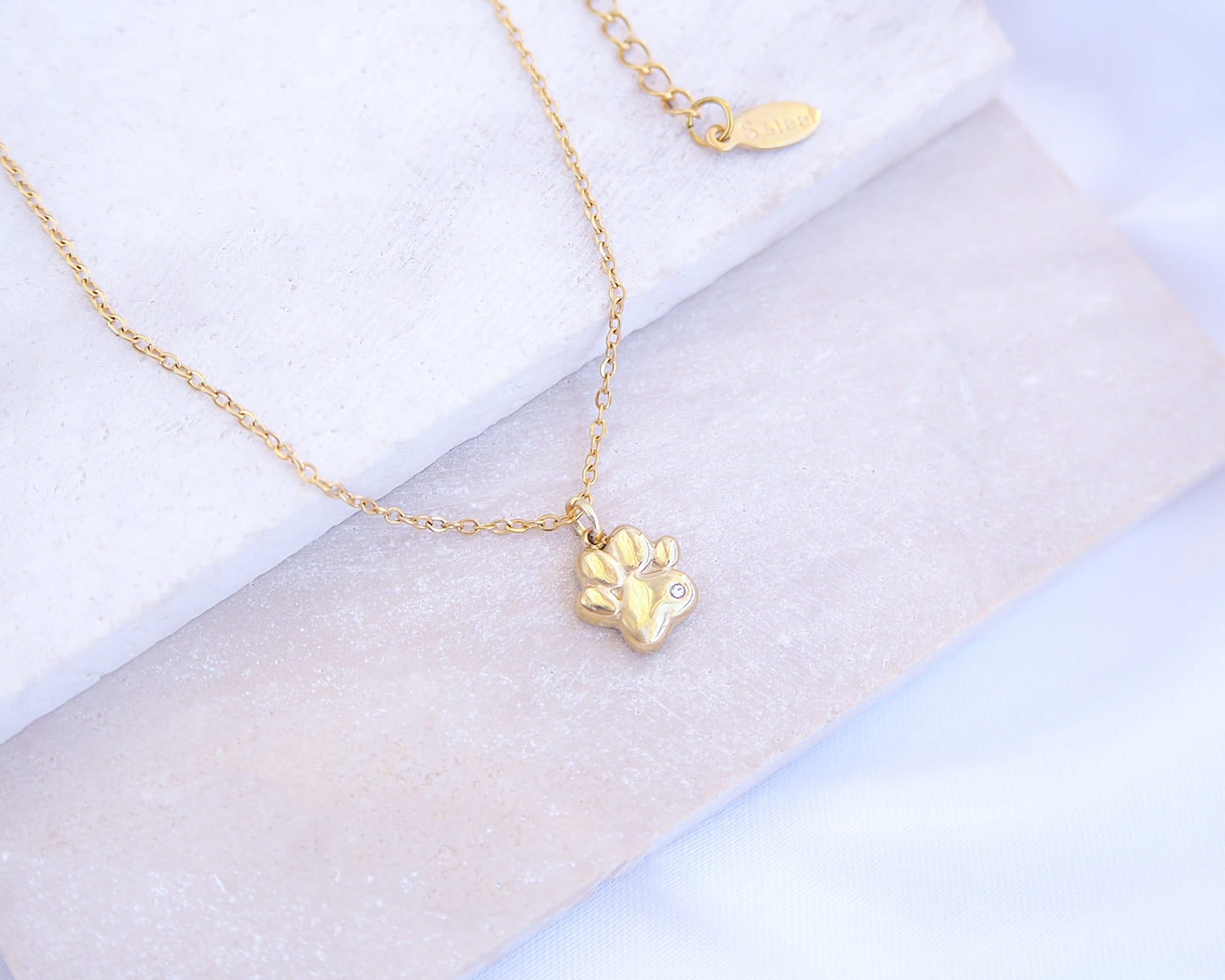 Tiny Cat Paw Gold Necklace on stone displayed, Memory Cat Jewelry, Gold Cat Necklace 