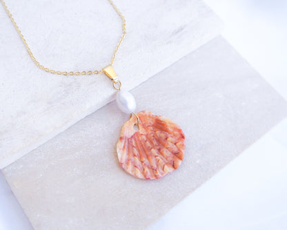 Tiny Coral Scallop Shell Pearl Necklace on display, Pilgrims Scallop Shell from Portugal with freshwater pearl and gold chain. 