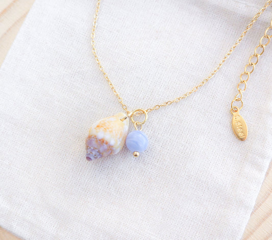 Tiny Light Rustic Dove with Angelite Gemstone Gold Necklace on display
