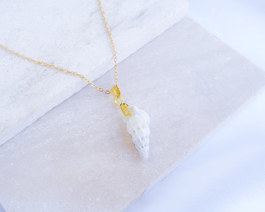 Tiny White Wentletrap Necklace backside displayed on stone