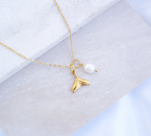 Dainty Gold Whale Tail Pearl Necklaces on stone with freshwater pearls and 18k gold whale pendant