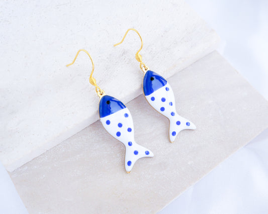 White Blue Polka Dot Sardine Fish Earrings  displayed on stone, 14k gold stainless steel earring hooks, summer drop earrings from Portugal