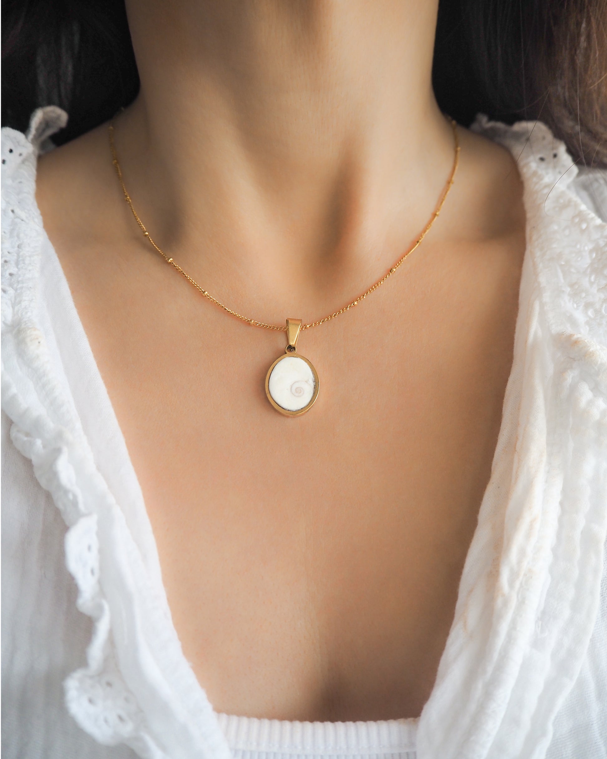 White Eye of Saint Lucia Gold Necklace on neck model, 18k gold stainless steel shiva eye pendant necklace, Saint Lucy Eye, operculum pendant