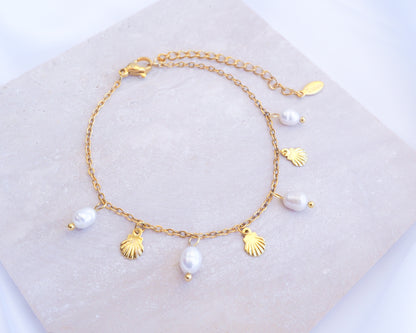 Gold Tiny Shell White Freshwater Pearl Bracelet displayed on stone, Dainty Gold Shell Bracelet